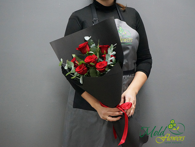 Bouquet of red roses, eucalyptus in black paper photo